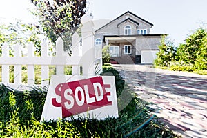beautiful new house with sign sold standing