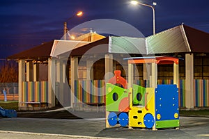 Beautiful new modern playground in kindergarten with soft rubber flooring and bright new multicolored big toy car