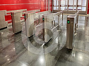 Beautiful new shiny metal automatic turnstiles for entering the subway or exiting the building