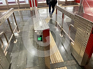 Beautiful new shiny metal automatic turnstiles for entering the subway or exiting the building