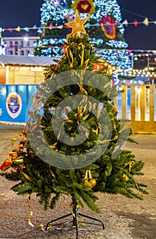 Beautiful new year view.Christmas tree on the background of Christmas lights and decorations