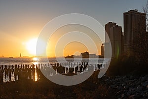 Beautiful New York City Sunset along the East River seen From the Shore of Brooklyn Heights in Silhouette