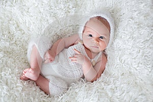 Beautiful newborn baby boy, looking coriously at camera