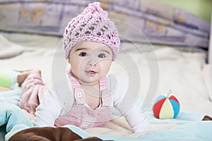Beautiful newborn baby girl in pink hat.