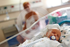 Beautiful newborn baby laying in crib in prenatal hospital