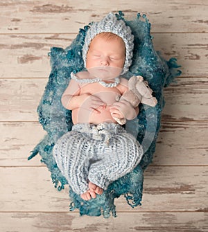 Beautiful newborn baby sleeping on woolen blanket