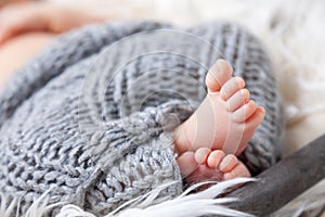 Beautiful newborn baby toes inside a basket