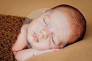 Beautiful newborn sleeping baby boy