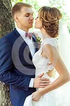 Beautiful newlyweds hugging in park