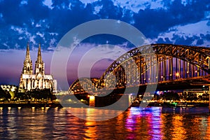 Beautiful night landscape of the Cologne, Germany with gothic cathedral, railway and pedestrian Hohenzollern Bridge and