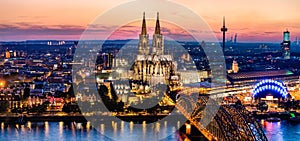 Beautiful night landscape of the gothic Cologne cathedral, Hohenzollern Bridge and the River Rhine at sunset and blue hour in