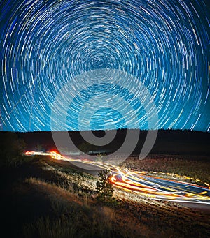 Beautiful night landscape, star tracks and car tracks