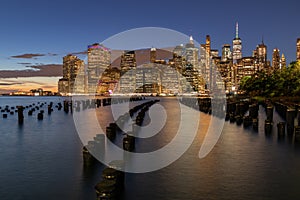 Beautiful Night Light and Lower Manhattan skyline with East River and New York City. Twilight with Reflections and Abandoned Pier