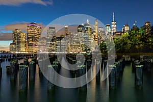 Beautiful Night Light and Lower Manhattan skyline with East River and New York City. Twilight with Reflections and Abandoned Pier