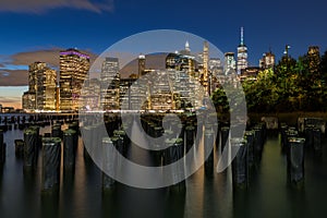 Beautiful Night Light and Lower Manhattan skyline with East River and New York City. Twilight with Reflections and Abandoned Pier