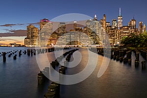 Beautiful Night Light and Lower Manhattan skyline with East River and New York City. Twilight with Reflections and Abandoned Pier