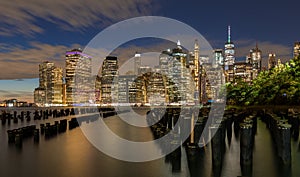 Beautiful Night Light and Lower Manhattan skyline with East River and New York City. Twilight with Reflections and Abandoned Pier