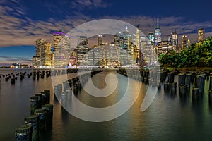 Beautiful Night Light and Lower Manhattan skyline with East River and New York City. Twilight with Reflections and Abandoned Pier