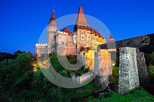 Beautiful night panorama of the Hunyad Castle / Corvin`s Castle with wooden bridge