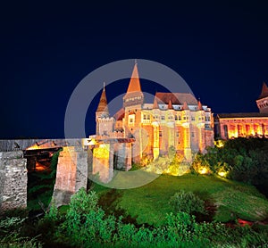 Beautiful night panorama of the Hunyad Castle / Corvin`s Castle with wooden bridge