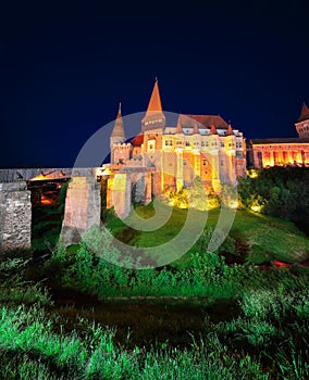 Beautiful night panorama of the Hunyad Castle / Corvin`s Castle with wooden bridge