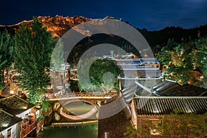 Beautiful night scenery at Gubei Water Town & Simatai Great Wall in the background - China