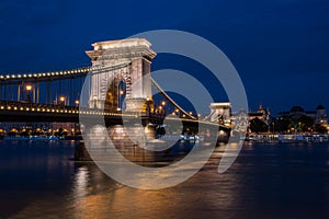 Beautiful night shot of the illuminated Chain Bridge in Budapest across the Danube river in Hungary.