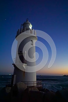 A beautiful night sky behind a White Lighthouse
