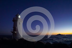 A beautiful night sky behind a White Lighthouse