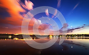 Beautiful night sky at the river with stars and clouds