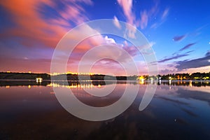 Beautiful night sky at the river with stars and clouds