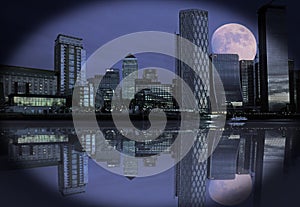 Beautiful night view of canary wharf in London with a composite moon surrounded by a vignette edge