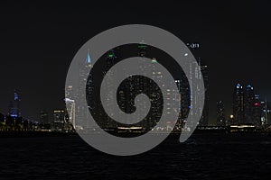 Beautiful night view of Dubai skyscrapers from the sea. skyline of Dubai Marina after sunset with a sea in the