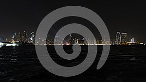 Beautiful night view of Dubai skyscrapers from the sea. skyline of Dubai Marina after sunset with a sea in the