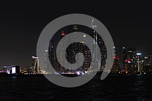 Beautiful night view of Dubai skyscrapers from the sea. skyline of Dubai Marina after sunset with a sea in the