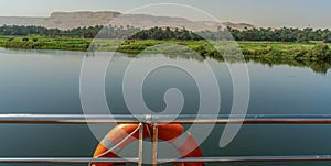 The beautiful Nile River with Luxor Mountain seen from a luxury cruise ship in Egypt.