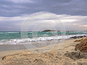 Beautiful Nissi beach with rolling sea with waves on a cloudy murky day in Ayia Napa, Cyprus