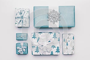 Beautiful nordic christmas gifts isolated on white background. Pastel blue colored wrapped xmas boxes. Gift wrapping.