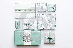 Beautiful nordic christmas gifts isolated on white background. Turquoise colored wrapped xmas boxes. Gift wrapping.