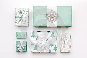 Beautiful nordic christmas gifts isolated on white background. Turquoise colored wrapped xmas boxes. Gift wrapping.