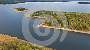 Beautiful northern landscape. lake with colorful forest and islands during golden autumn. Top aerial view from drone