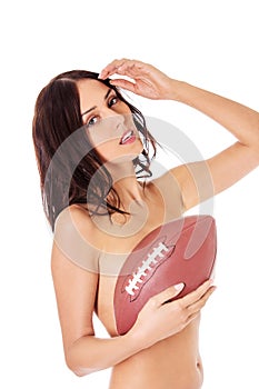 Beautiful nude woman holding american football ball.