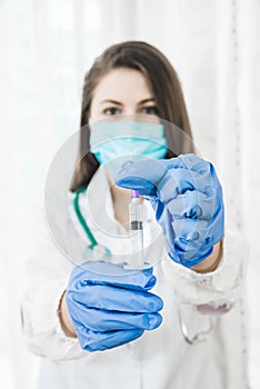 Beautiful nurse ready for injection, syringe with medicament