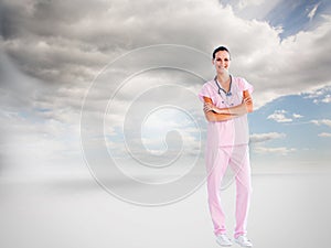 Beautiful nurse standing in front of the camera with folded arms