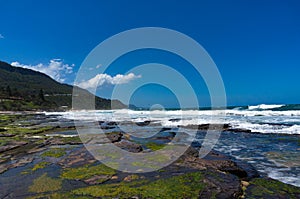 Beautiful ocean beach with rocky shore