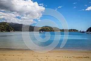 Beautiful ocean landscape with a sandy beach and boat view, Abel Tasman National Park