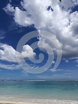 Beautiful ocean view with torquise water and dramatic clouds on sky