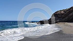 Beautiful oceanscape with rocky coastline lively waves sun and blue sky