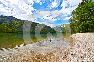 Beautiful Offensee lake landscape with mountains, forest, clouds and resting-place in Austrian Alps. Salzkammergut region