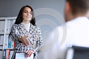Beautiful office woman holds out her hand to man